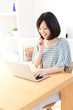 a young asian woman using laptop computer