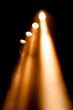 Four spotlights with orange beams
