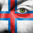 Flag painted on face with green eye to show Faroe island support