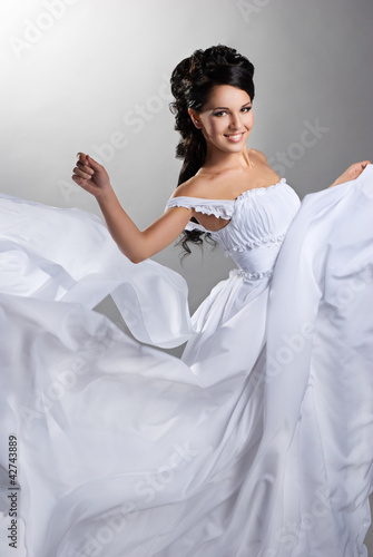 Photo: Fiance and the wind. Woman in a wedding dress Fiance and the wind. Woman in a wedding dress