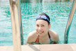 Photo: Close up woman swimming in swimming pool. Close up woman swimming in swimming pool.