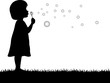 little girl blowing soap bubbles