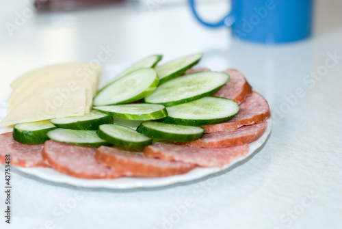 Photo: Cut cheese, sausage and cucumber in a plate Cut cheese, sausage and cucumber in a plate