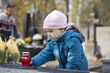 Girl mourning at the grave on cemetery in Warsaw