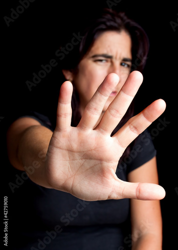 Foto: Frightened woman with her hand extended for protection Frightened woman with her hand extended for protection