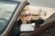 Young woman in a convertible car