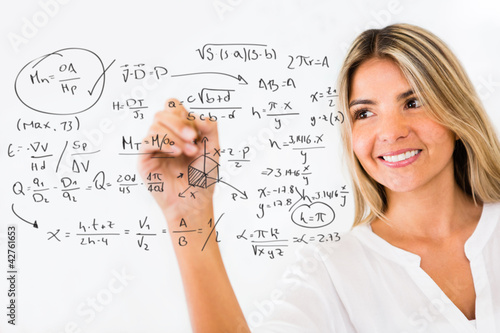 Photo: Female student writing formulas Female student writing formulas