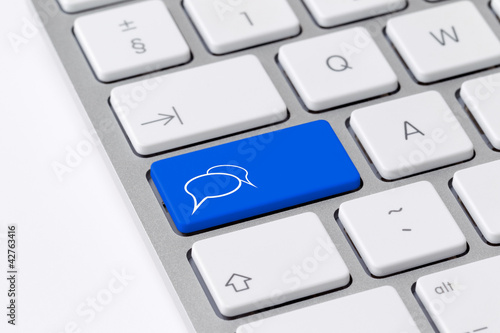 Photo: Keyboard with a single blue button showing the chat icon Keyboard with a single blue button showing the chat icon