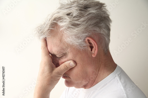 Photo: side view of man who is embarrassed or disappointed side view of man who is embarrassed or disappointed