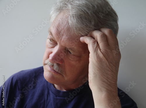 Photo: senior man preoccupied with his thoughts senior man preoccupied with his thoughts