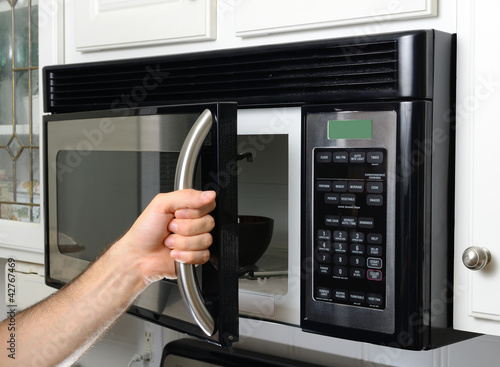 Photo: Hand Opening Microwave Hand Opening Microwave