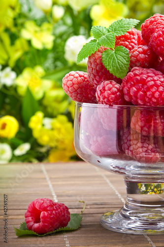 Photo: Sweet fresh raspberry fruits in glass goblet Sweet fresh raspberry fruits in glass goblet