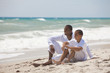 Happy African American Father and Son On Beach
