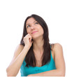 Photo: woman talking on the phone, smiling and looking up in office woman talking on the phone, smiling and looking up in office