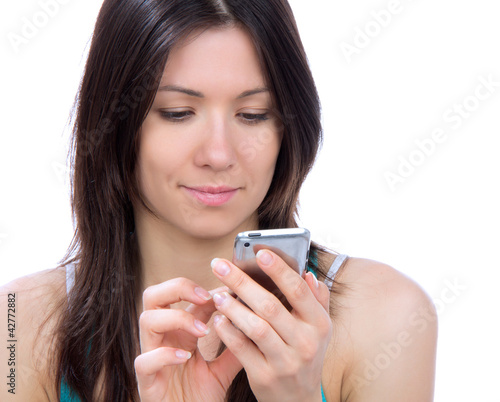 Photo: Young woman texting on mobile cell phone mobile Young woman texting on mobile cell phone mobile