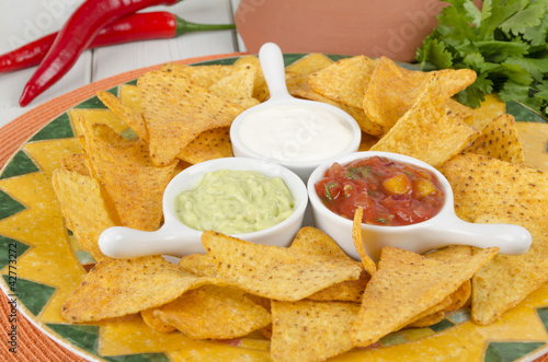 Photo: Nachos - Tortilla Chips with guacamole, salsa & sour cream dips Nachos - Tortilla Chips with guacamole, salsa & sour cream dips