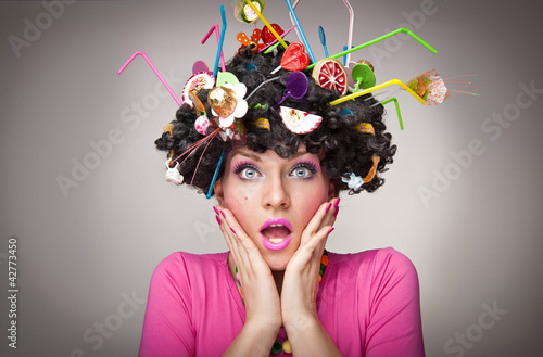 Photo: beautiful surprised female with lollipops in the hair beautiful surprised female with lollipops in the hair