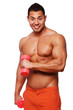Portrait of muscle man posing in studio with dumbbells