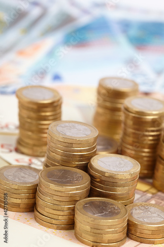 Photo: Euro coins on banknote money background Euro coins on banknote money background