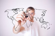Photo: young man drawing a world map young man drawing a world map