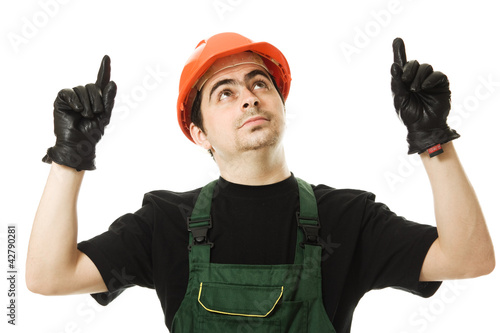 Photo: Businessman in helmet pointing up. Businessman in helmet pointing up.