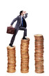 Businessman climbing gold coins stacks