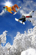 Snowboarders jumping against blue sky