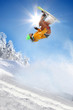 Snowboarder jumping against blue sky