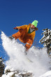 Snowboarder jumping against blue sky