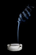 Cigarettes and smoke in ash-tray