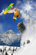 Snowboarder jumping against blue sky