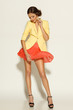 Foto: Full length of female posing in mini skirt fluttering on wind Full length of female posing in mini skirt fluttering on wind
