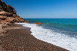 Beautiful small pebble beach on the coast of Costa Dorado, Spain
