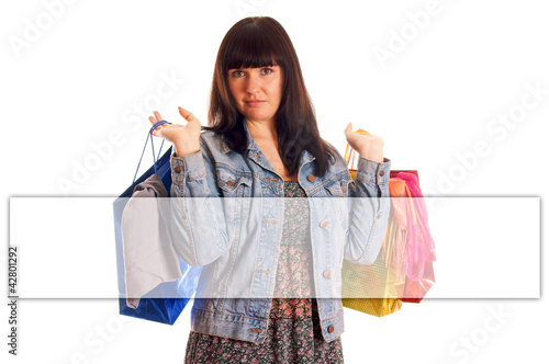 Foto: Woman with shopping bags and empty banner Woman with shopping bags and empty banner