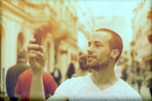 Photo: Man Take Photo With Mobile Phone On Street Man Take Photo With Mobile Phone On Street