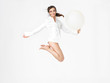 happy young woman jumping with balloon