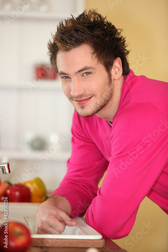 Photo: Young man in a kitchen Young man in a kitchen