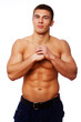 Photo: Portrait of muscle man posing on white background in studio Portrait of muscle man posing on white background in studio