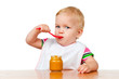 canvas print picture - Girl eats with a spoon