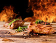 Grilled beef steaks with flames on background