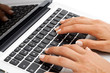 Macro close up of female hands on keyboard.