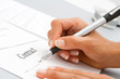 Photo: Macro close up of hand signing contract. Macro close up of hand signing contract.