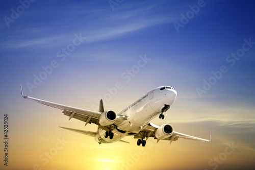 Photo: Jet Aeroplane Landing at Sunset Blue Yellow Copy Space Jet Aeroplane Landing at Sunset Blue Yellow Copy Space