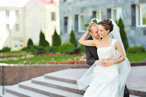 Photo: Bride and groom having fun in an old town Bride and groom having fun in an old town