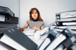 Photo: Business woman working in office with documents Business woman working in office with documents