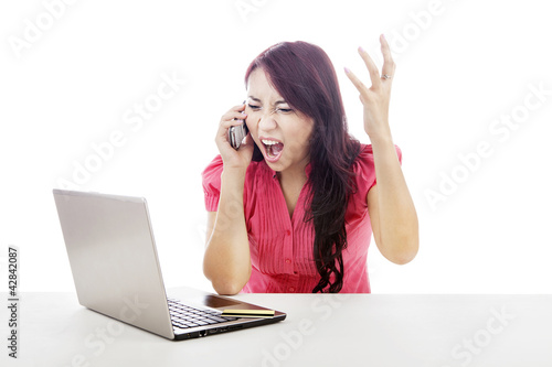 Photo: Angry woman shouting on the phone Angry woman shouting on the phone