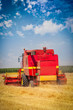 Combine harvesting wheat
