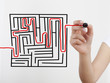 Woman hand drawing, solving maze
