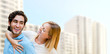 Young couple in front of modern house building. Planning to buy