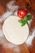 Pizza dough with tomato and basil